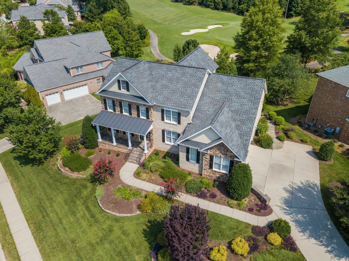 A large house with many trees and bushes